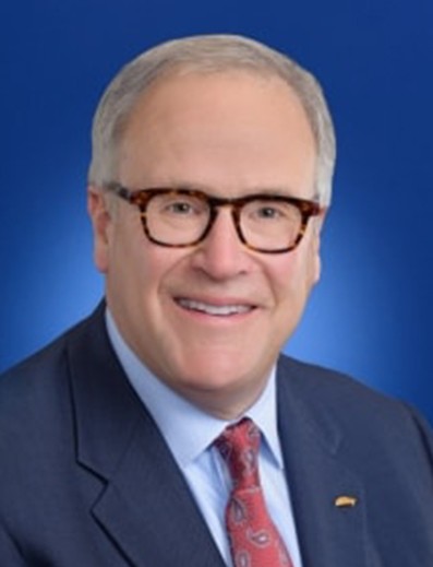Male employee smiles for camera